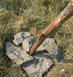 rock with names and stick